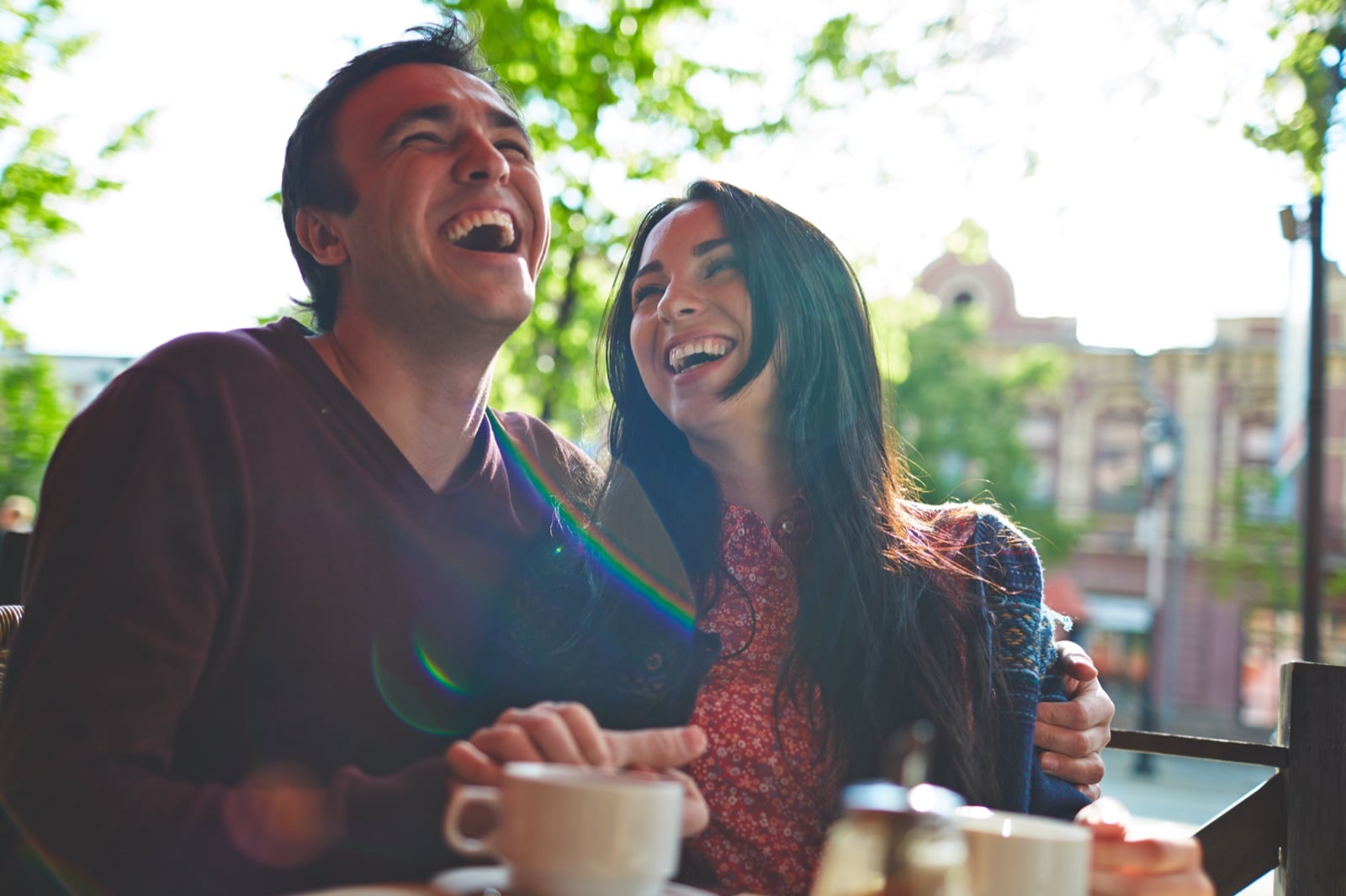 Diverse couple laughing together outdoors